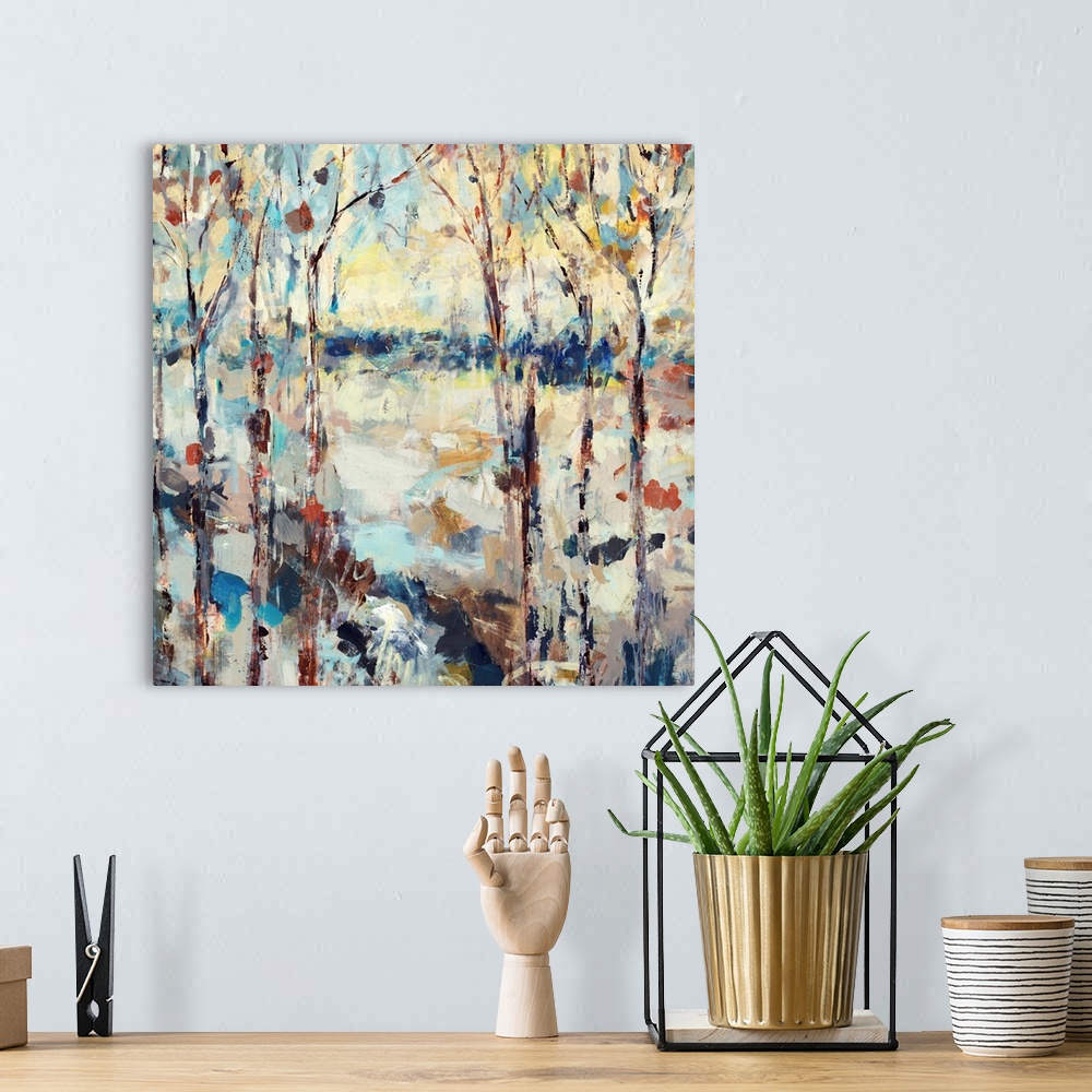 A bohemian room featuring A dramatic abstract painting of a path through a forest on square shaped wall art.