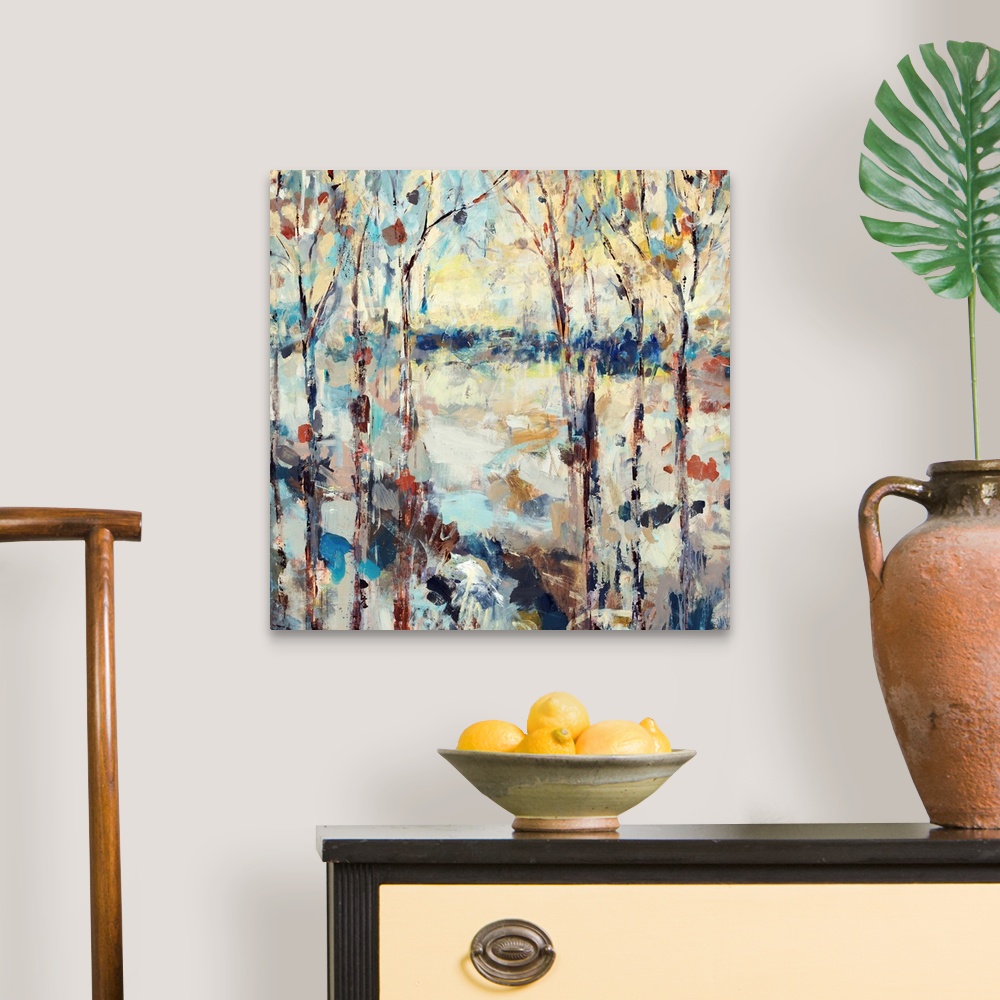 A traditional room featuring A dramatic abstract painting of a path through a forest on square shaped wall art.