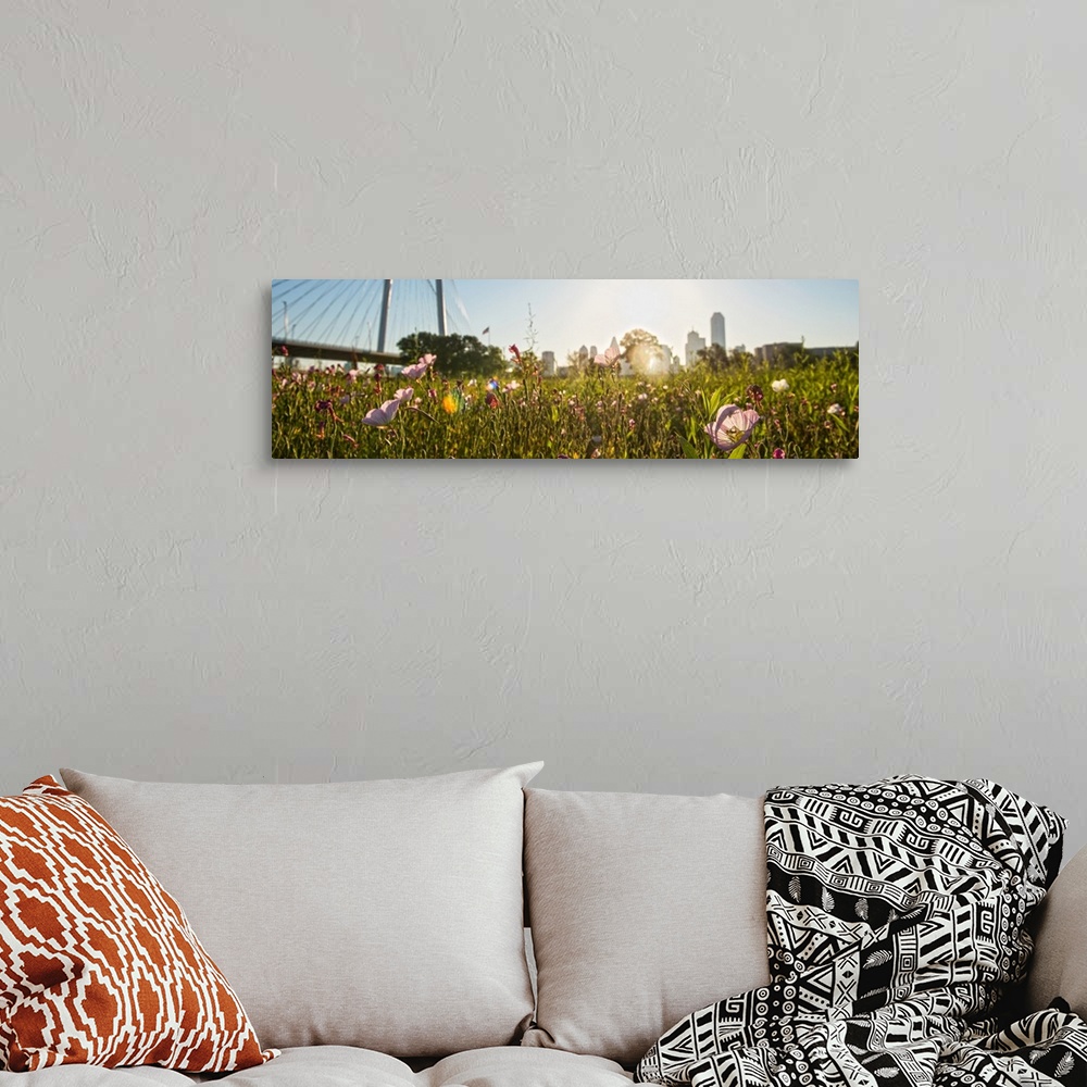 A bohemian room featuring Wildflowers fill the foreground with Margaret Hunt Hill bridge and Dallas city in the background.