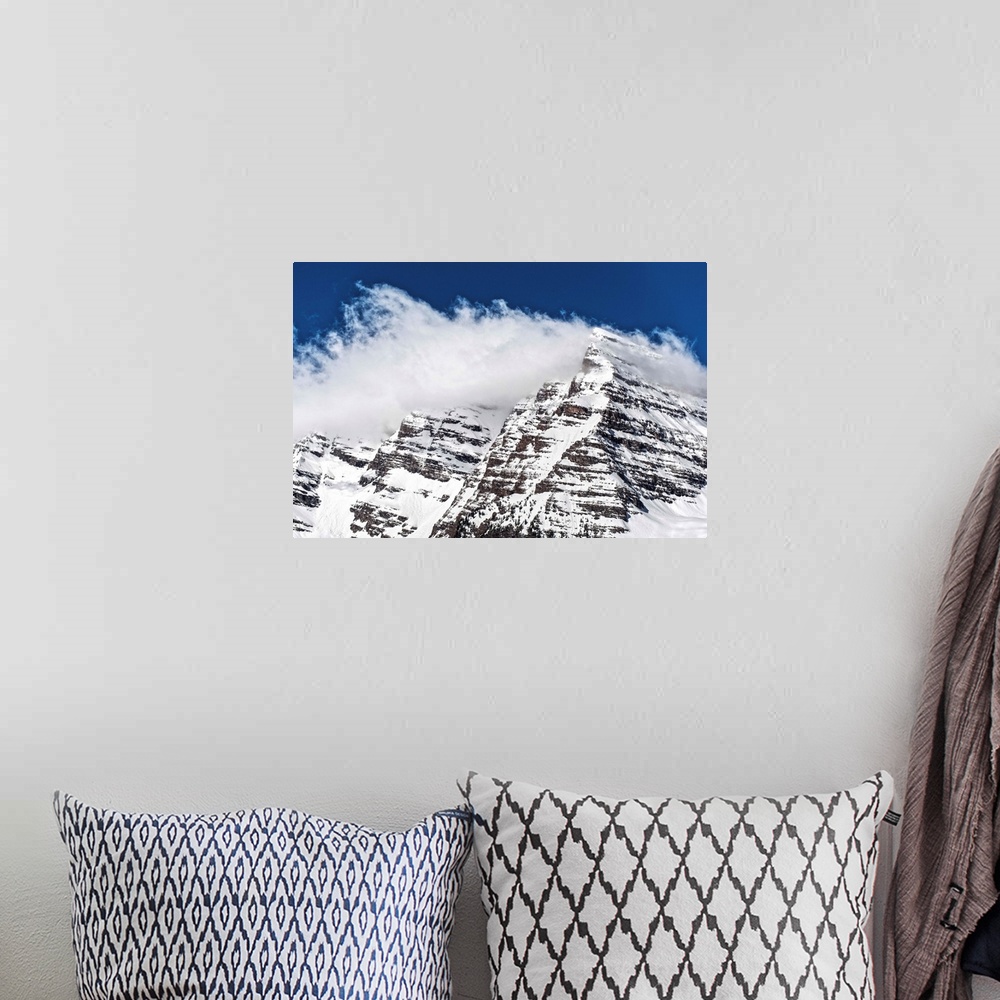 A bohemian room featuring Wind-blown snow on the peaks of the Maroon Bells under a blue sky in Aspen, Colorado.