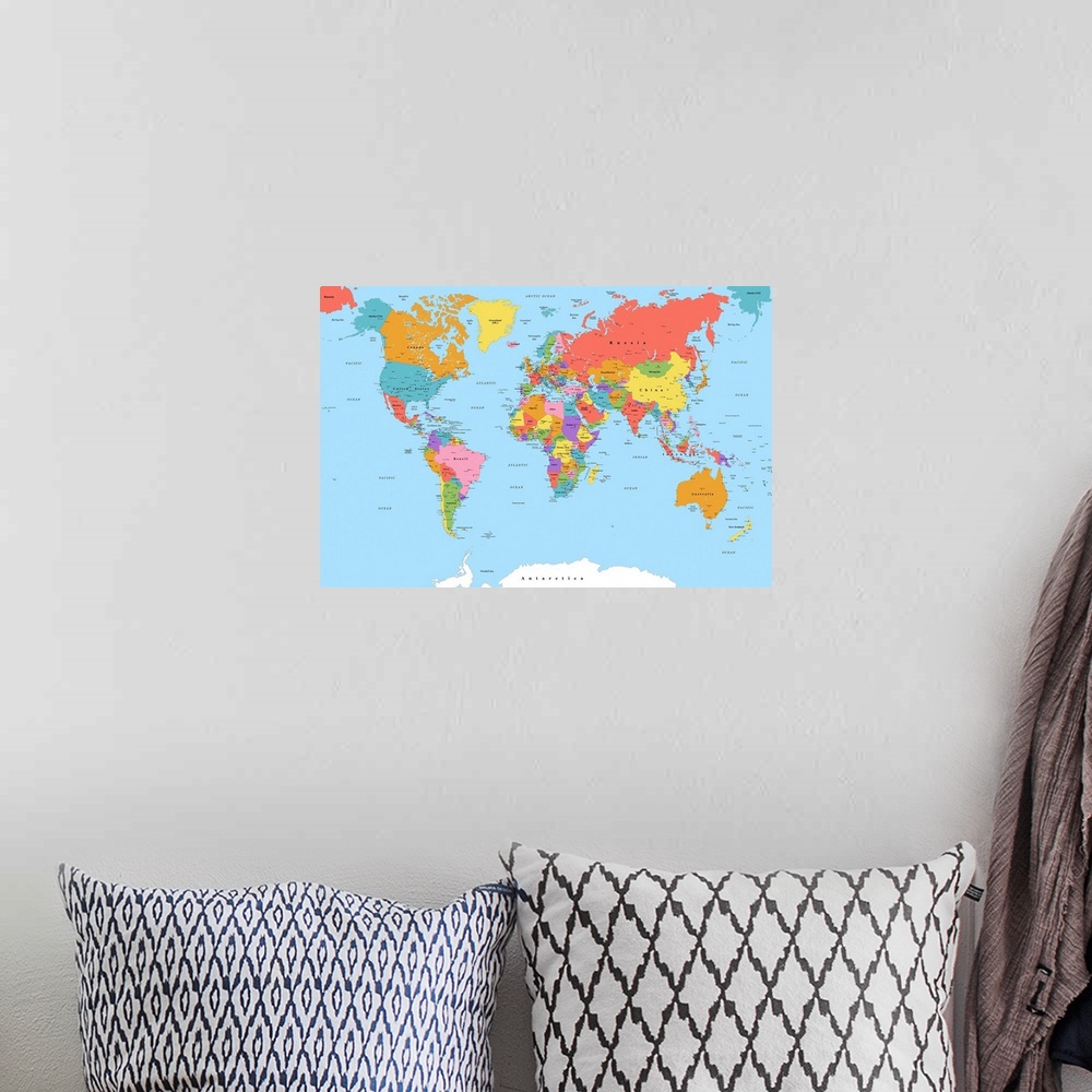 A bohemian room featuring Large color map of the World with a classic font.