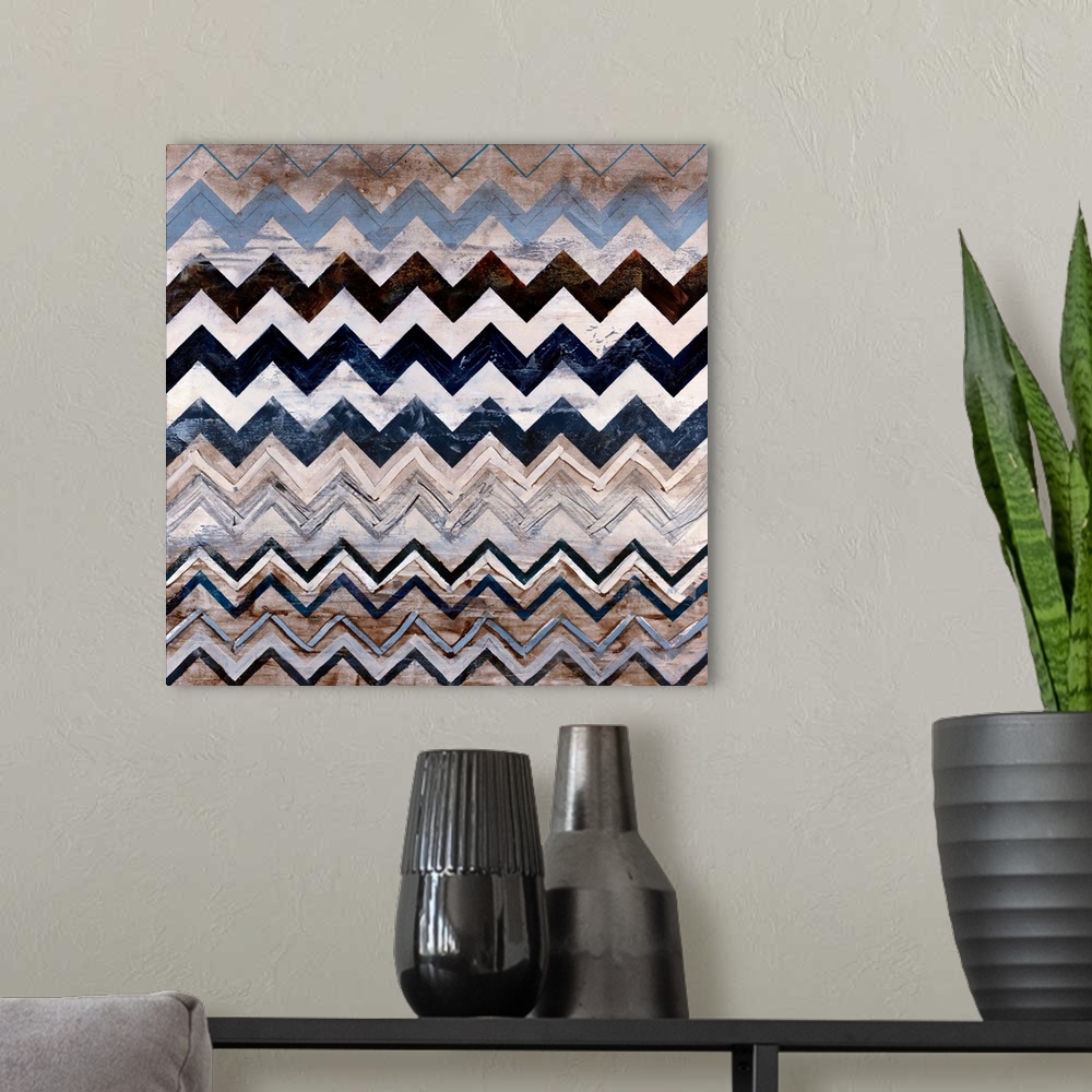 A modern room featuring Abstract contemporary painting of a triangular pattern done in neutral earth tones on a square ca...