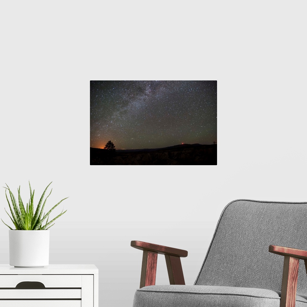 A modern room featuring Silhouette photograph of Zion National Park at night time with a starry sky above.