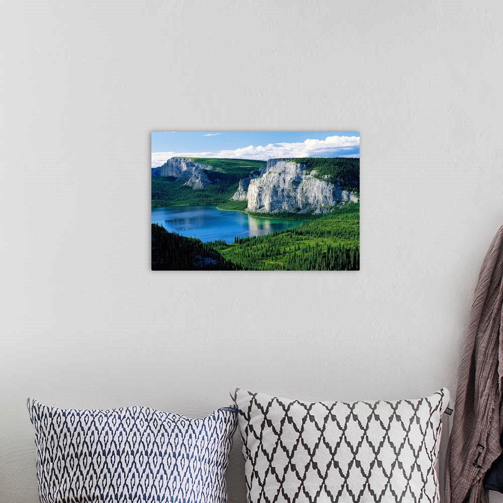 A bohemian room featuring Photograph taken of immense cliffs known as Death Lake. The land is blanketed with trees and the ...