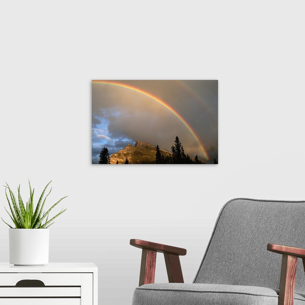 A modern room featuring Rainbow over Mt. Rundle after an early evening thunderstorm.
