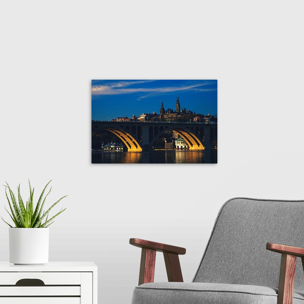 A modern room featuring Dusk view of Georgetown U. above Key Bridge over the Potomac River.