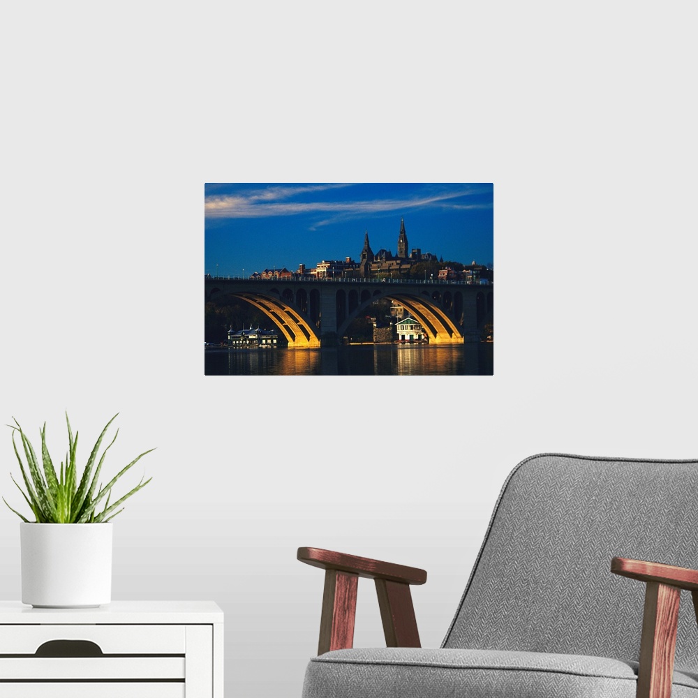A modern room featuring Dusk view of Georgetown U. above Key Bridge over the Potomac River.