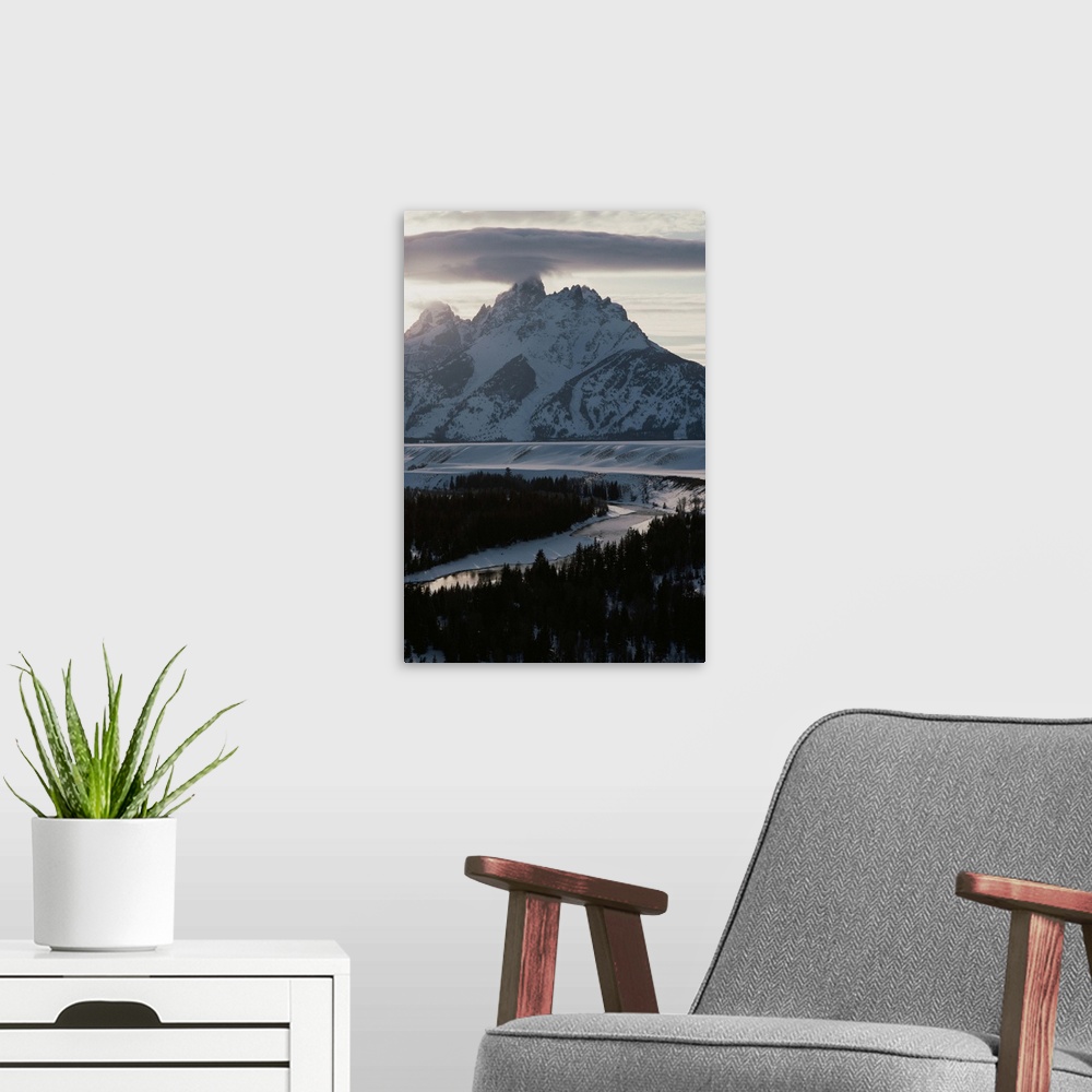 A modern room featuring Grand Teton Mountain and the Snake River in winter.