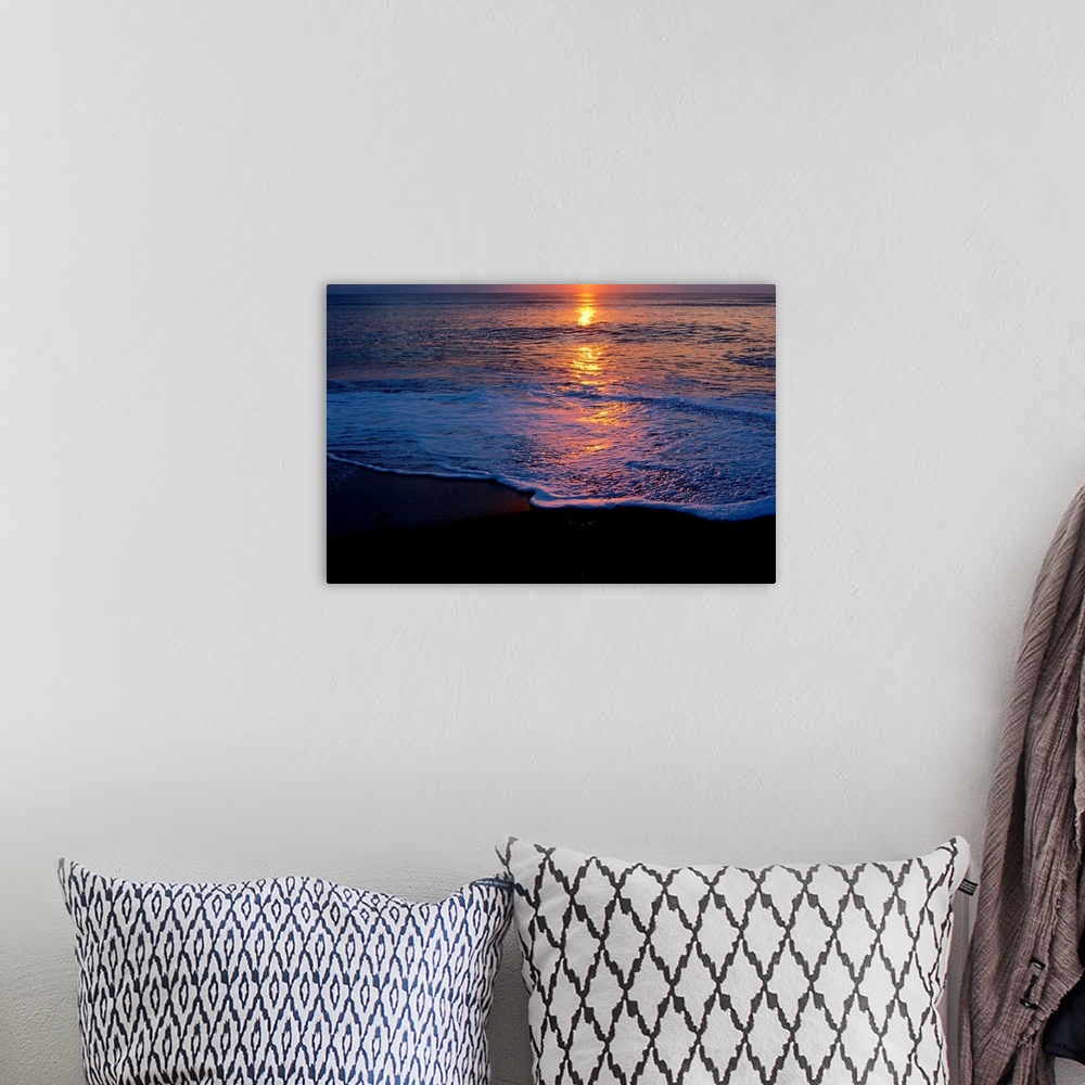 A bohemian room featuring Kitty Hawk Beach at sunset.