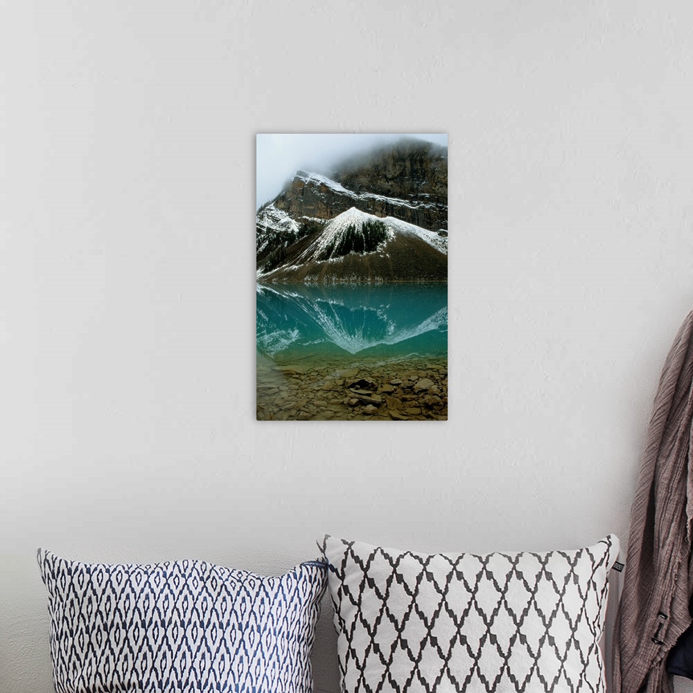 A bohemian room featuring Fog has lifted from Lake Louise and reflections of the snow-capped mountains ar e visible in this...