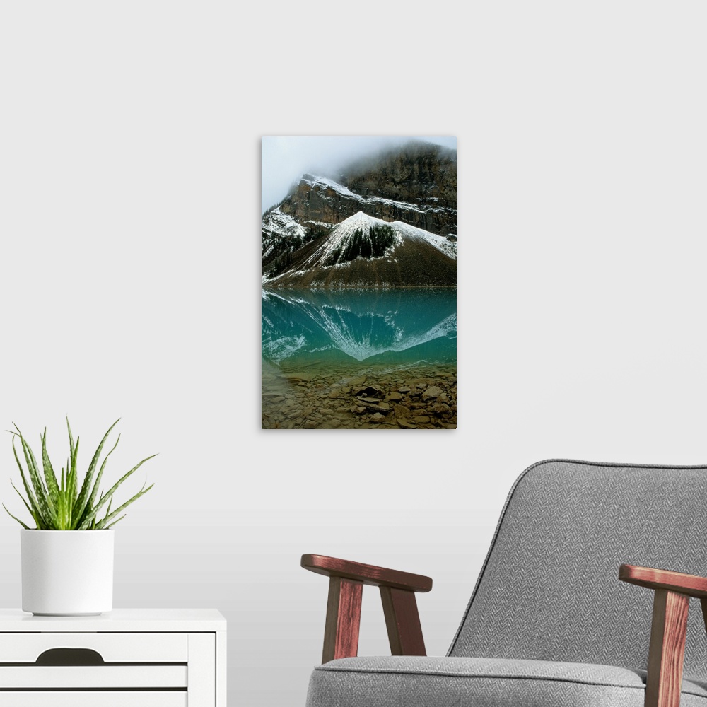 A modern room featuring Fog has lifted from Lake Louise and reflections of the snow-capped mountains ar e visible in this...