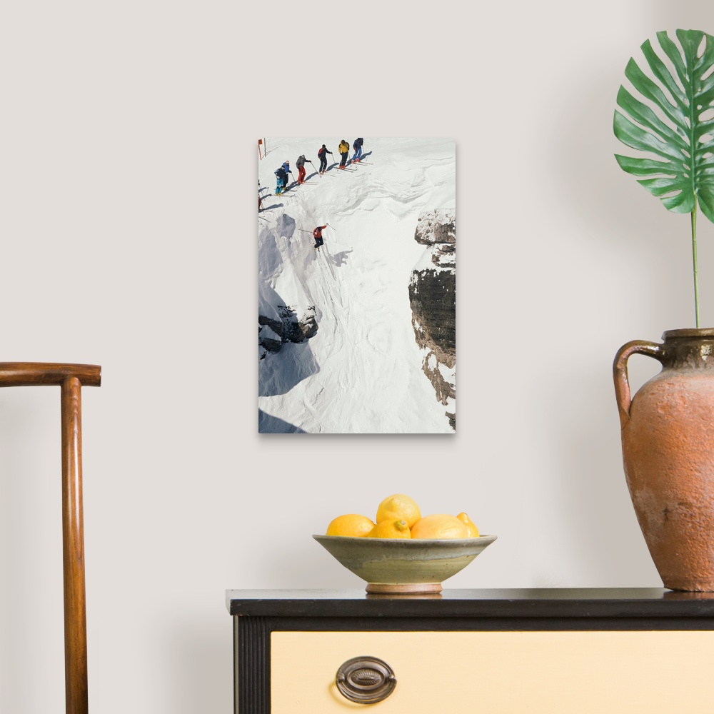 A traditional room featuring Skilled skiers plunge more than 15 feet in Corbet's Couloir.