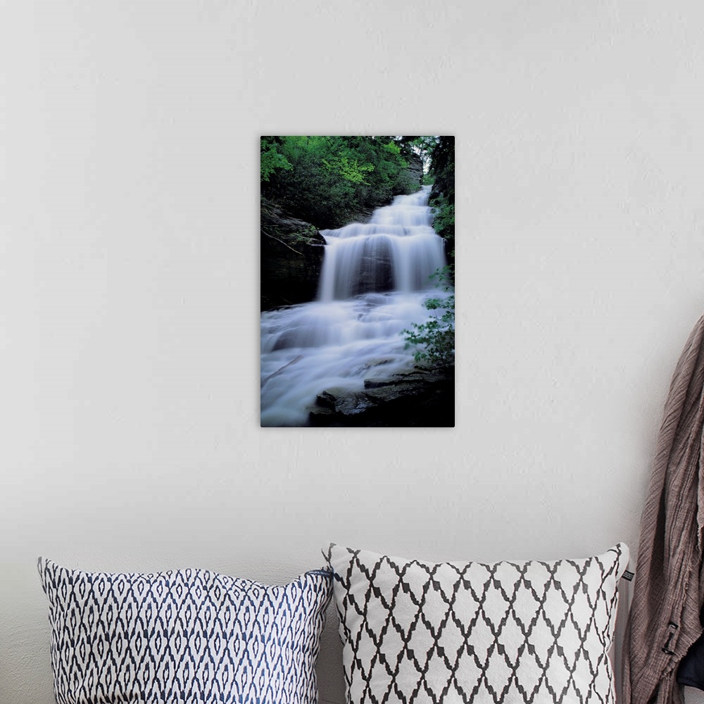 A bohemian room featuring Upper Cascades Falls flows down a mountain in Hanging Rock State Park.