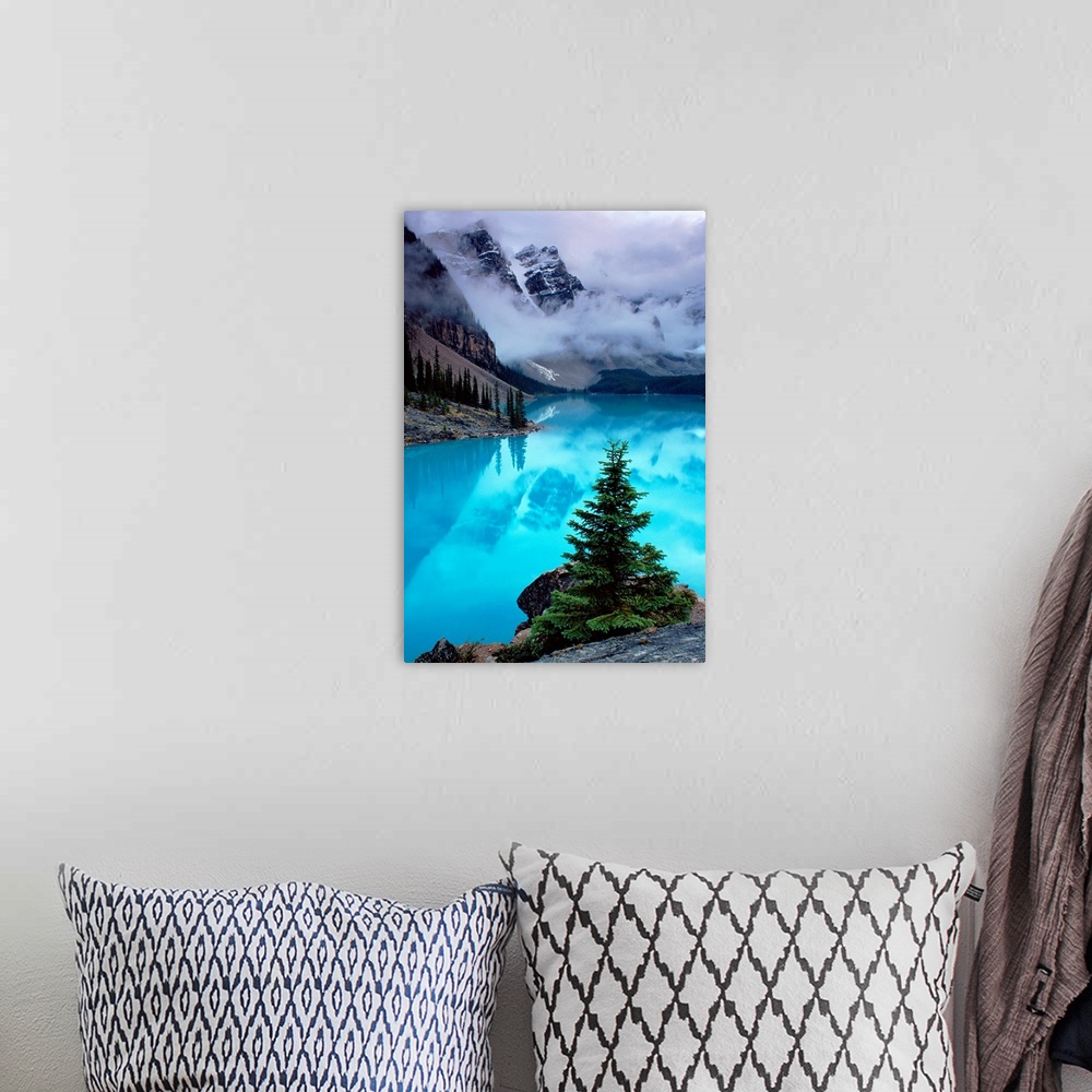 A bohemian room featuring From the National Geographic Collection a photograph of mountains reflecting in water as clouds p...
