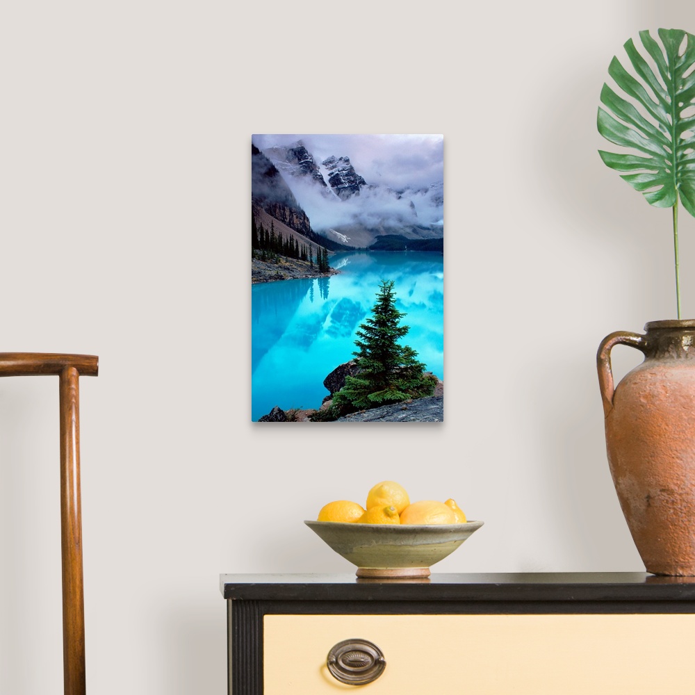 A traditional room featuring From the National Geographic Collection a photograph of mountains reflecting in water as clouds p...