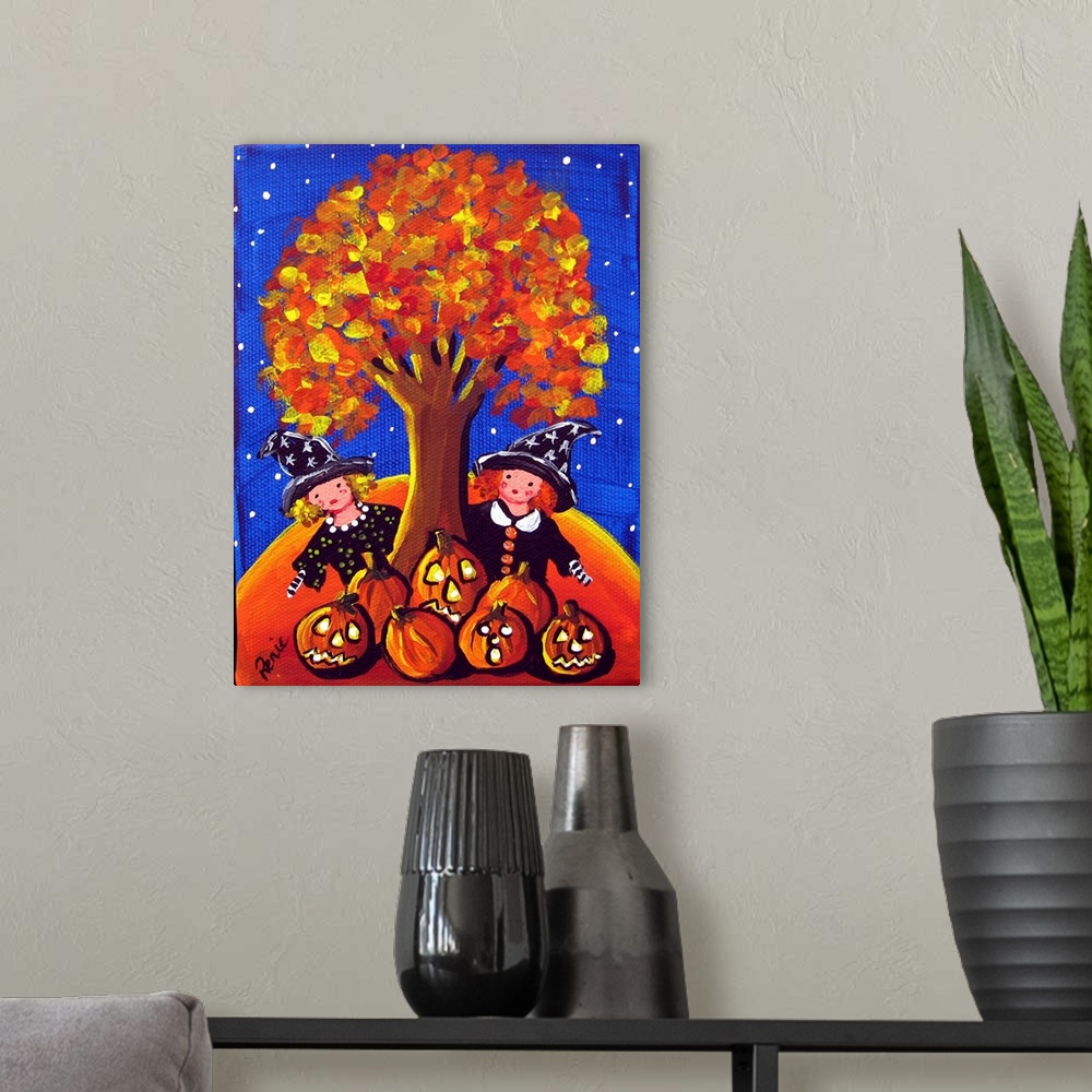 A modern room featuring Two little witches are peeking out from behind a colorful fall tree. A grouping of Jack-O-Lantern...