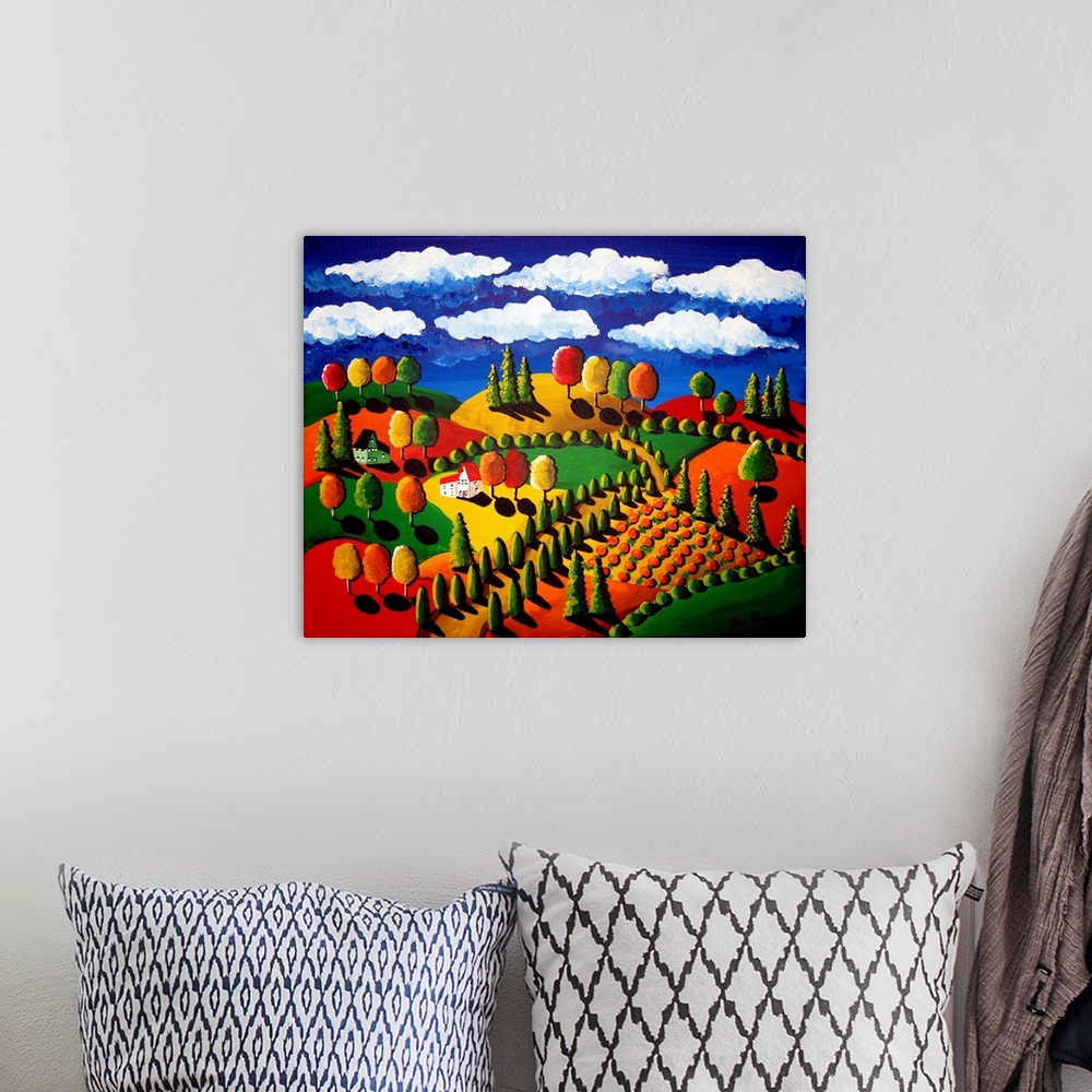 A bohemian room featuring Fun, whimsical, folk art piece depicting houses, trees, farmland, rolling hills with lots of color.