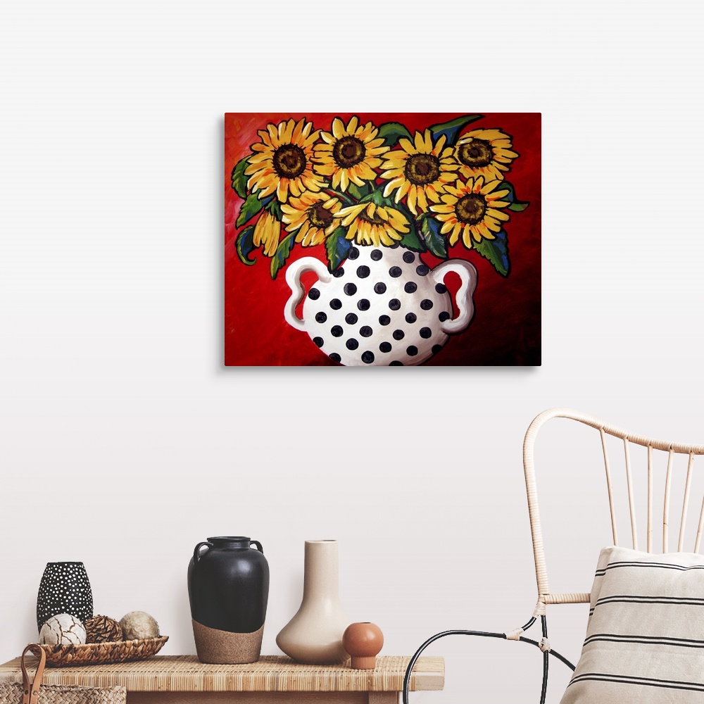 A farmhouse room featuring Whimsical flavor with brightly colored sunflowers in a black and white vase.