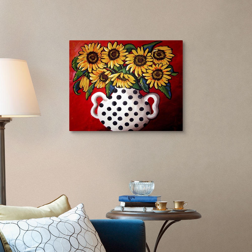 A traditional room featuring Whimsical flavor with brightly colored sunflowers in a black and white vase.