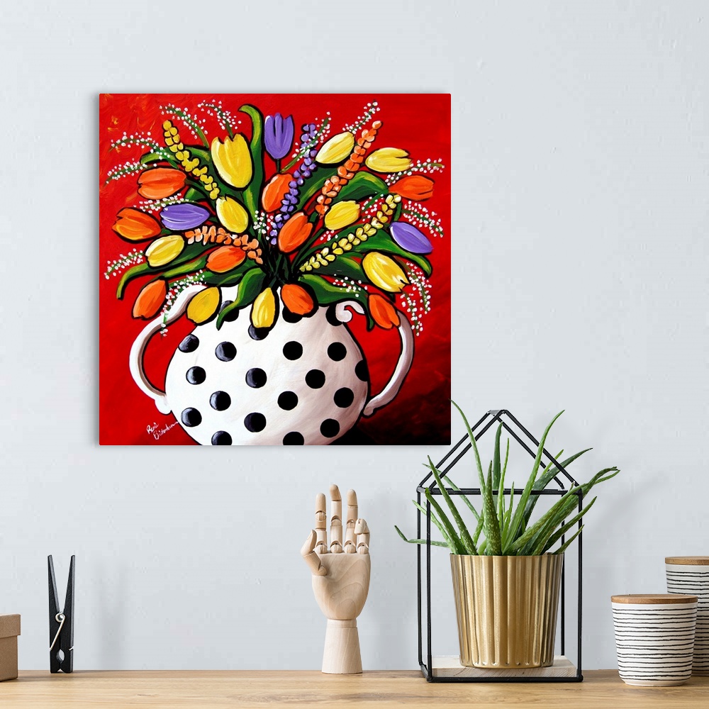 A bohemian room featuring Fun, brightly colored polka dot vase filled with spring flowers and Tulips.