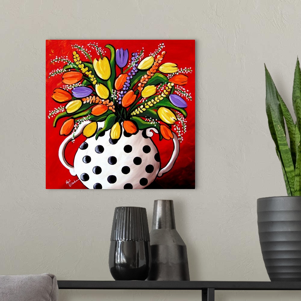 A modern room featuring Fun, brightly colored polka dot vase filled with spring flowers and Tulips.
