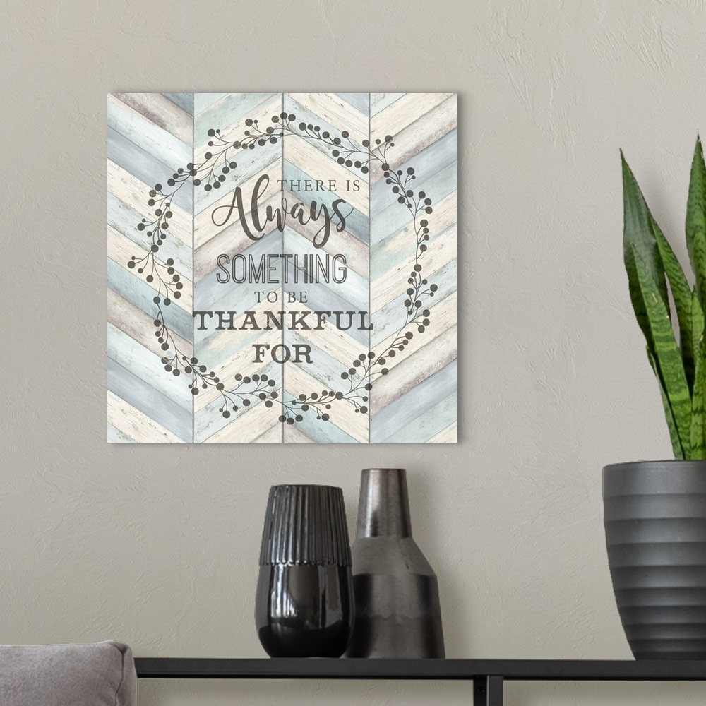 A modern room featuring "There Is Always Something To Be Thankful For" surround by a wreath on a chevron wood background.