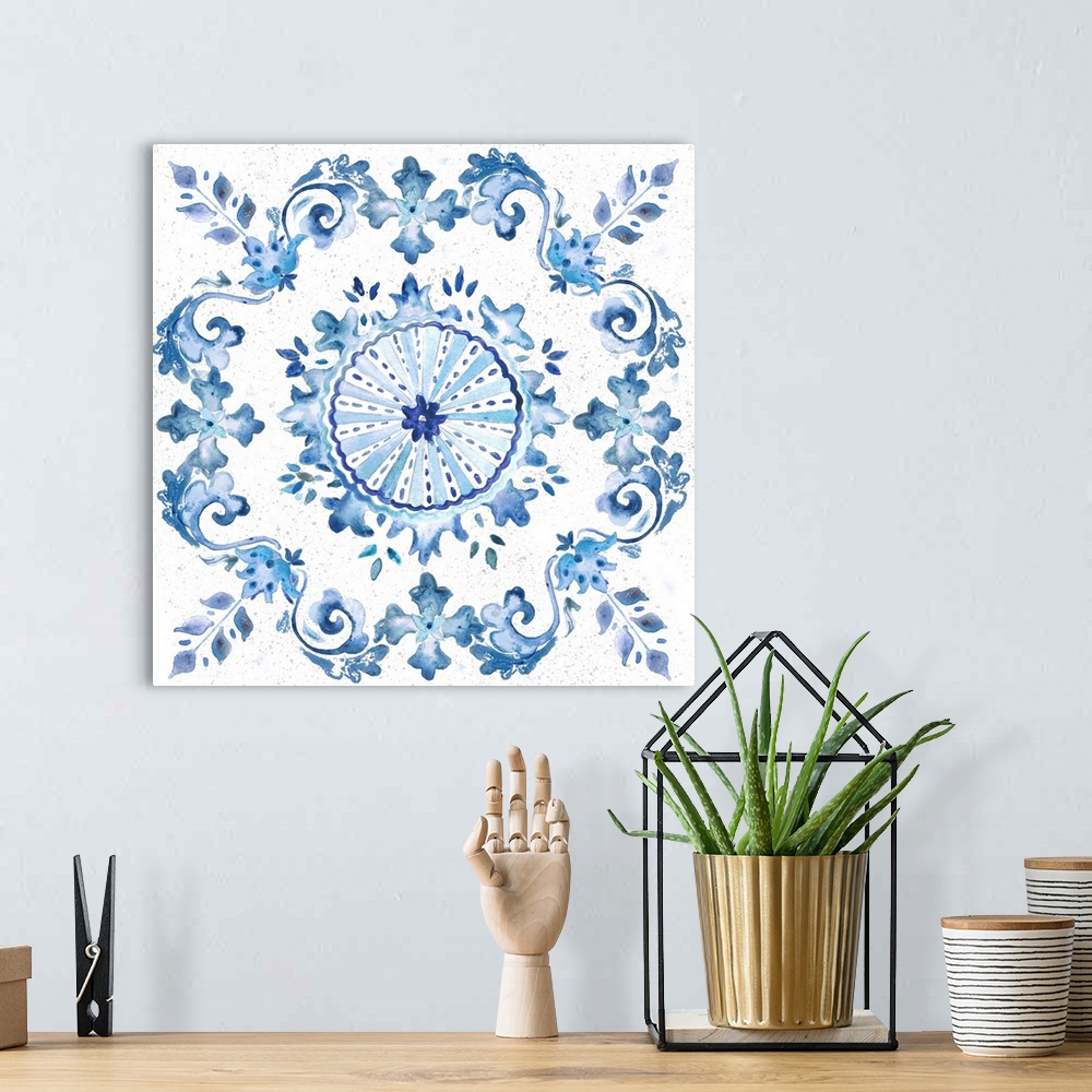 A bohemian room featuring A watercolor painting of a floral medallion design in blue and white.