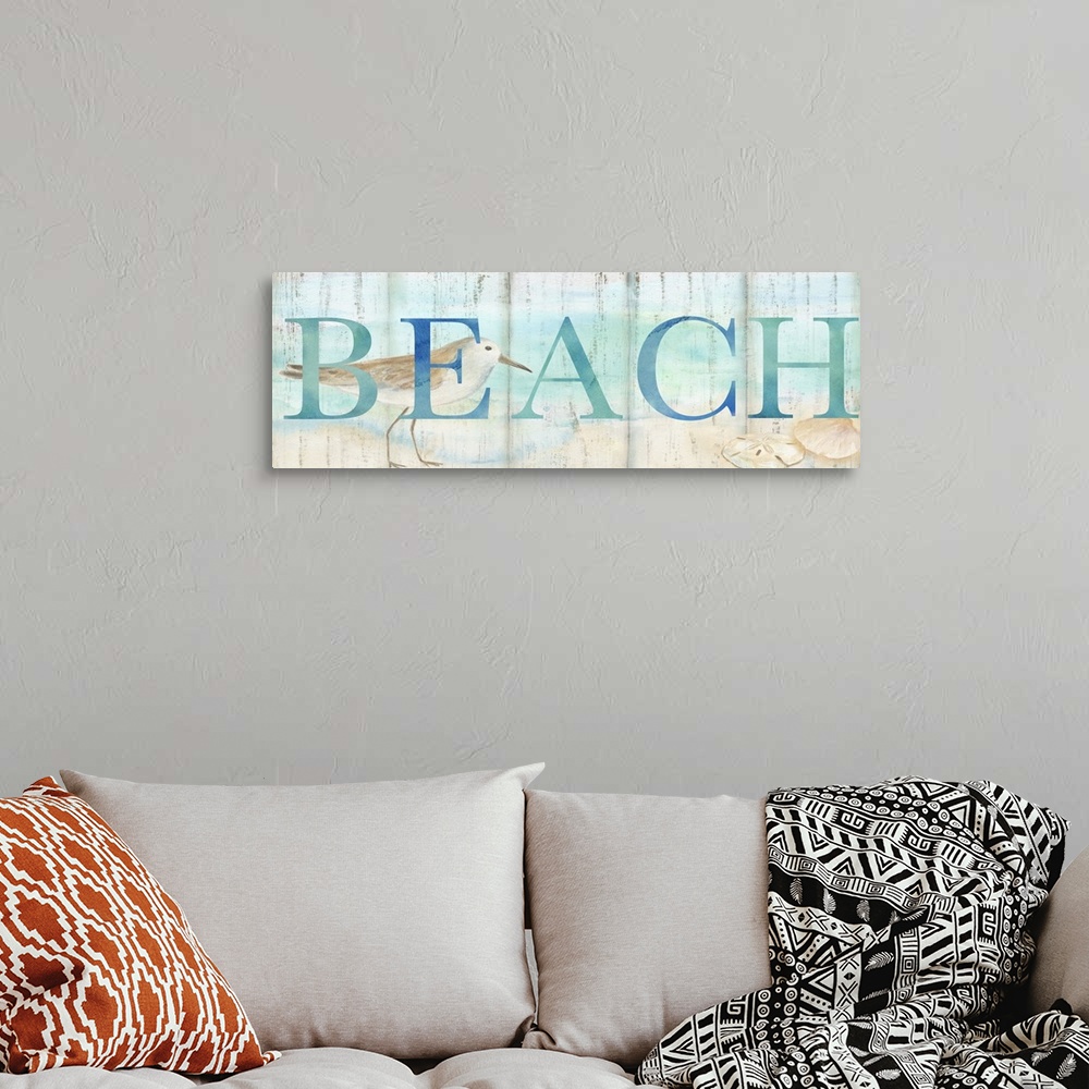 A bohemian room featuring "Beach" in blue over a watercolor image of a shorebird on a beach with a wood plank appearance.