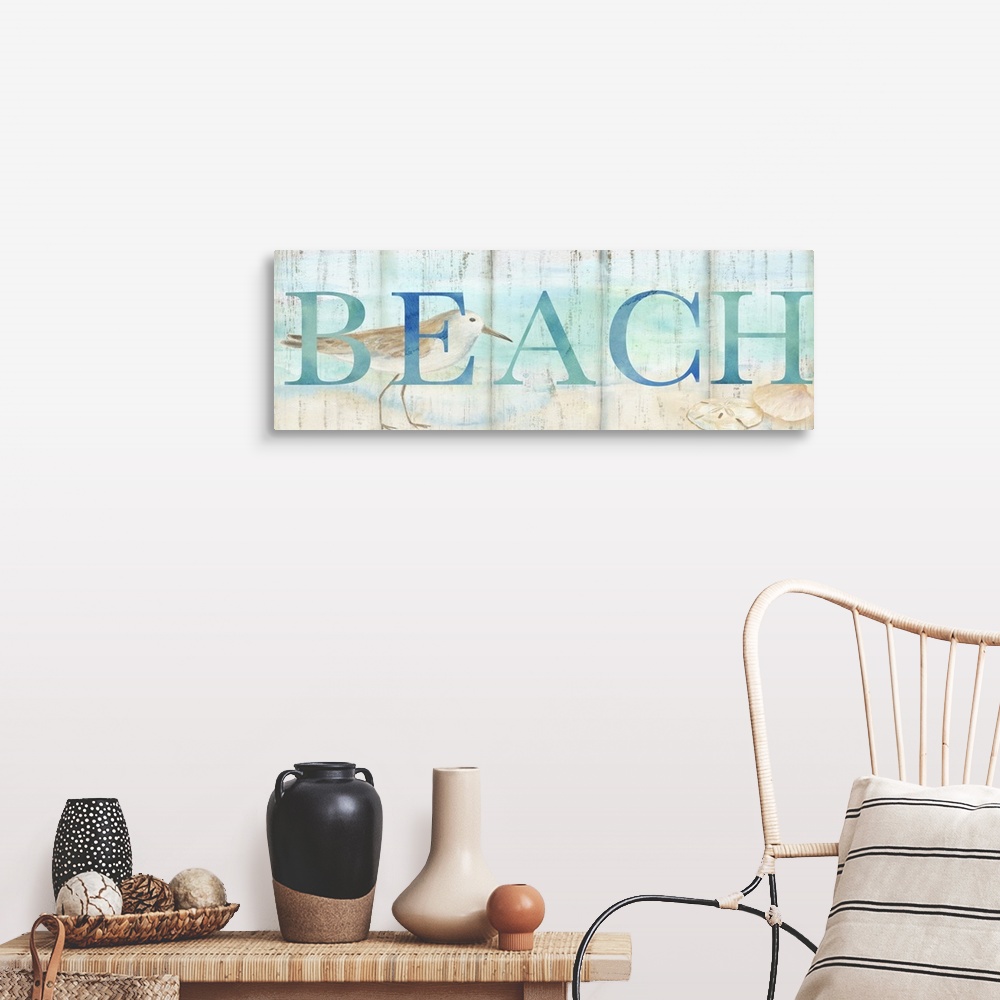 A farmhouse room featuring "Beach" in blue over a watercolor image of a shorebird on a beach with a wood plank appearance.