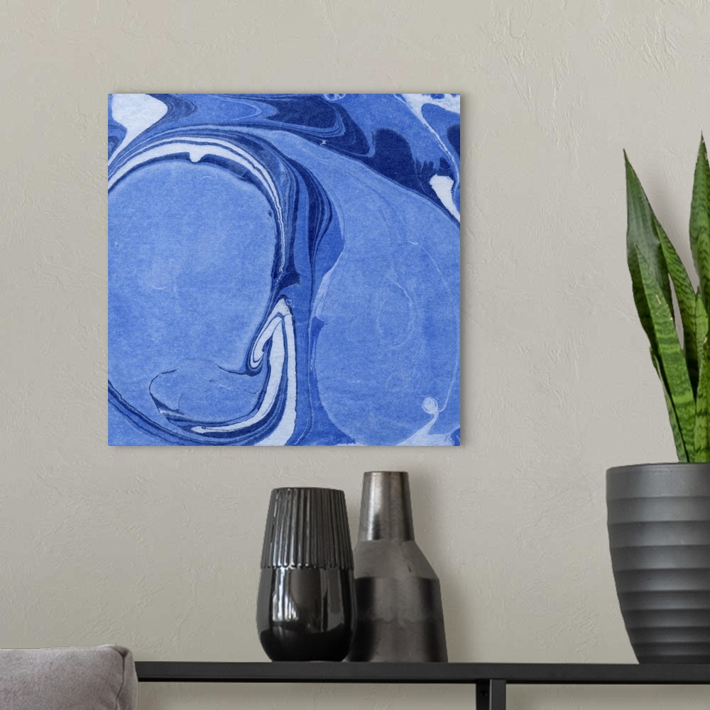 A modern room featuring Square decorative artwork of shades of blue in a marble design.