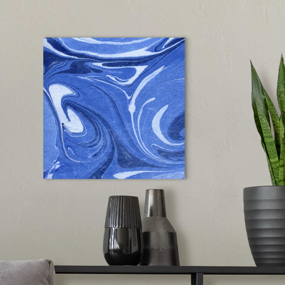 A modern room featuring Square decorative artwork of shades of blue in a marble design.