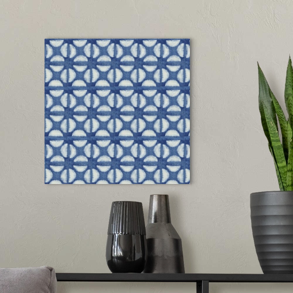 A modern room featuring Decorative design of rows of white circles with lines going through them on blue linen.