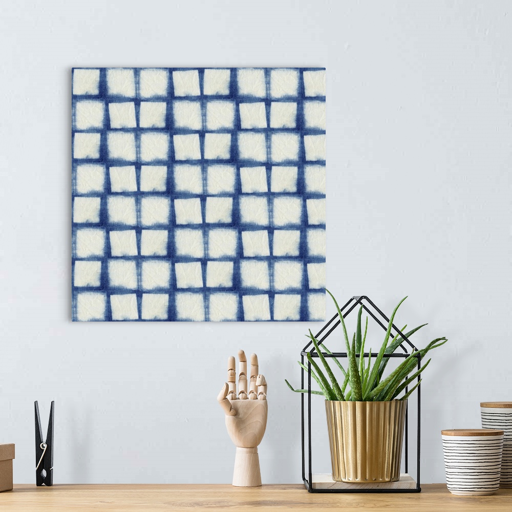 A bohemian room featuring Decorative design of rows of white squares on blue linen.