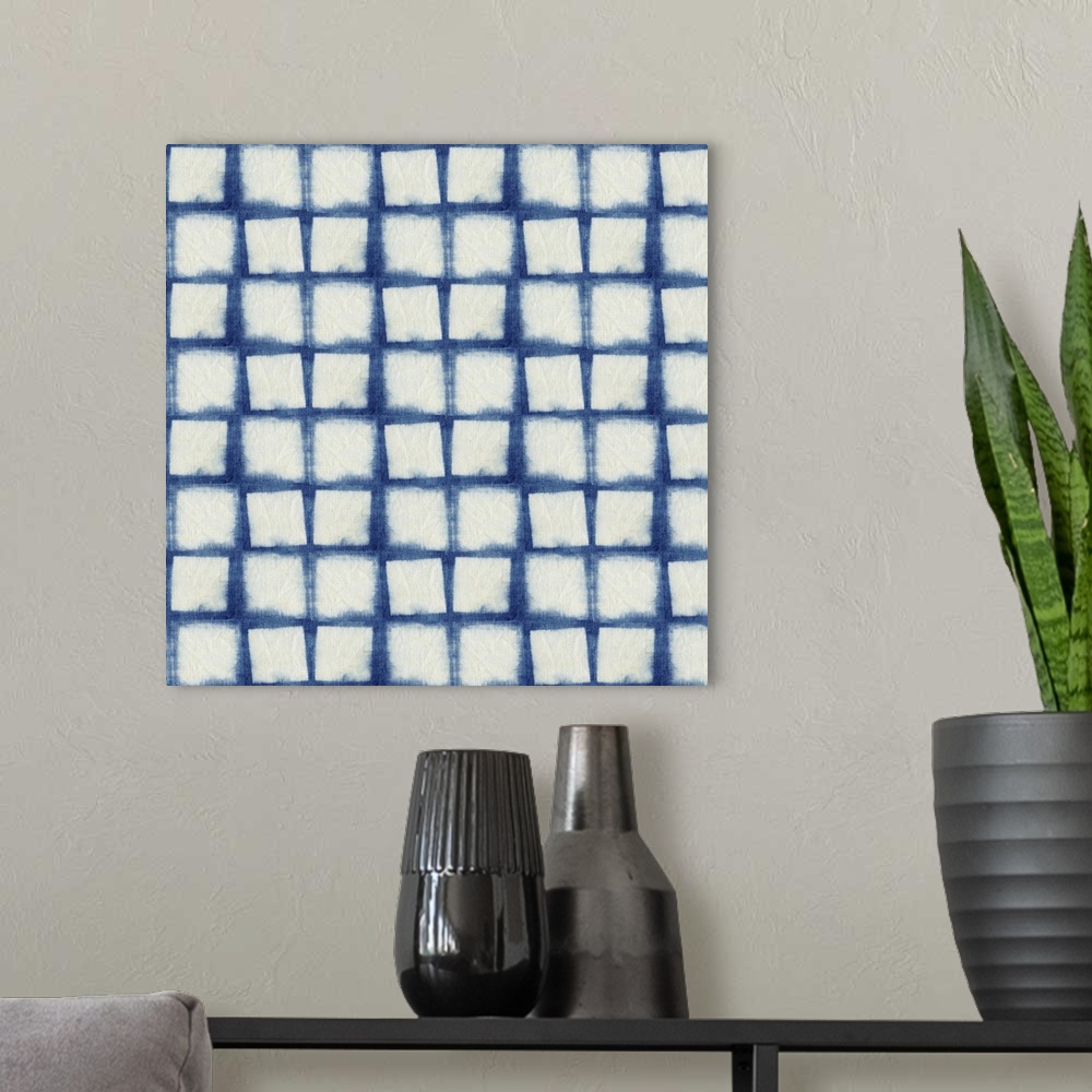 A modern room featuring Decorative design of rows of white squares on blue linen.
