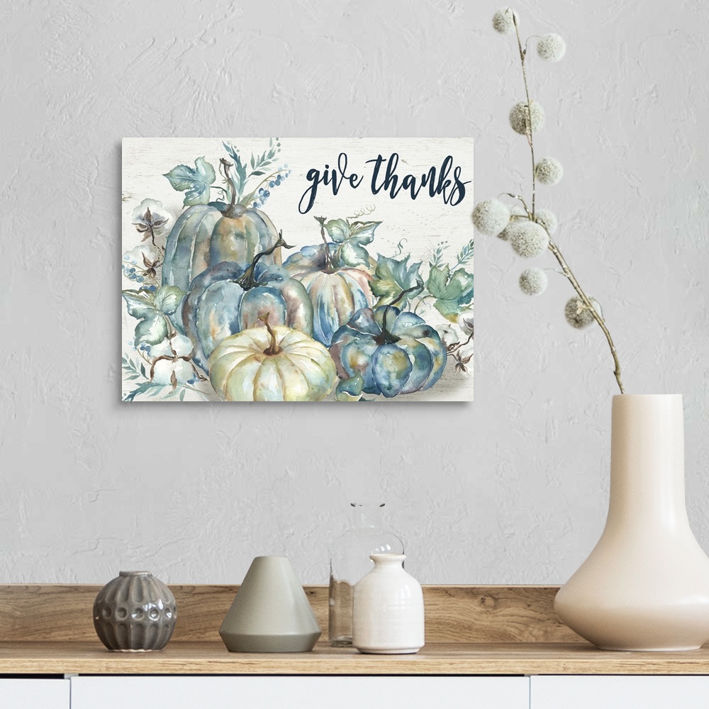 A farmhouse room featuring "Give Thanks" on a watercolor painting of a group of pumpkins with autumn leaves.