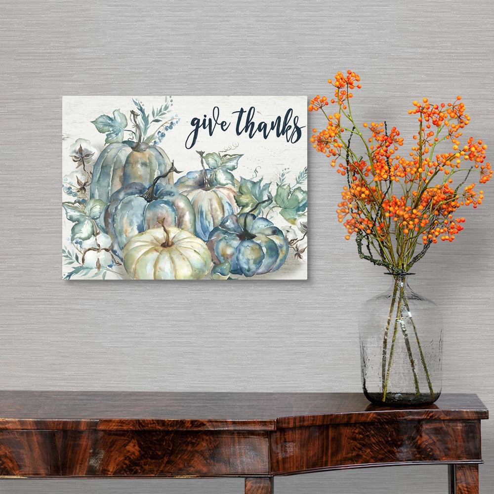 A traditional room featuring "Give Thanks" on a watercolor painting of a group of pumpkins with autumn leaves.