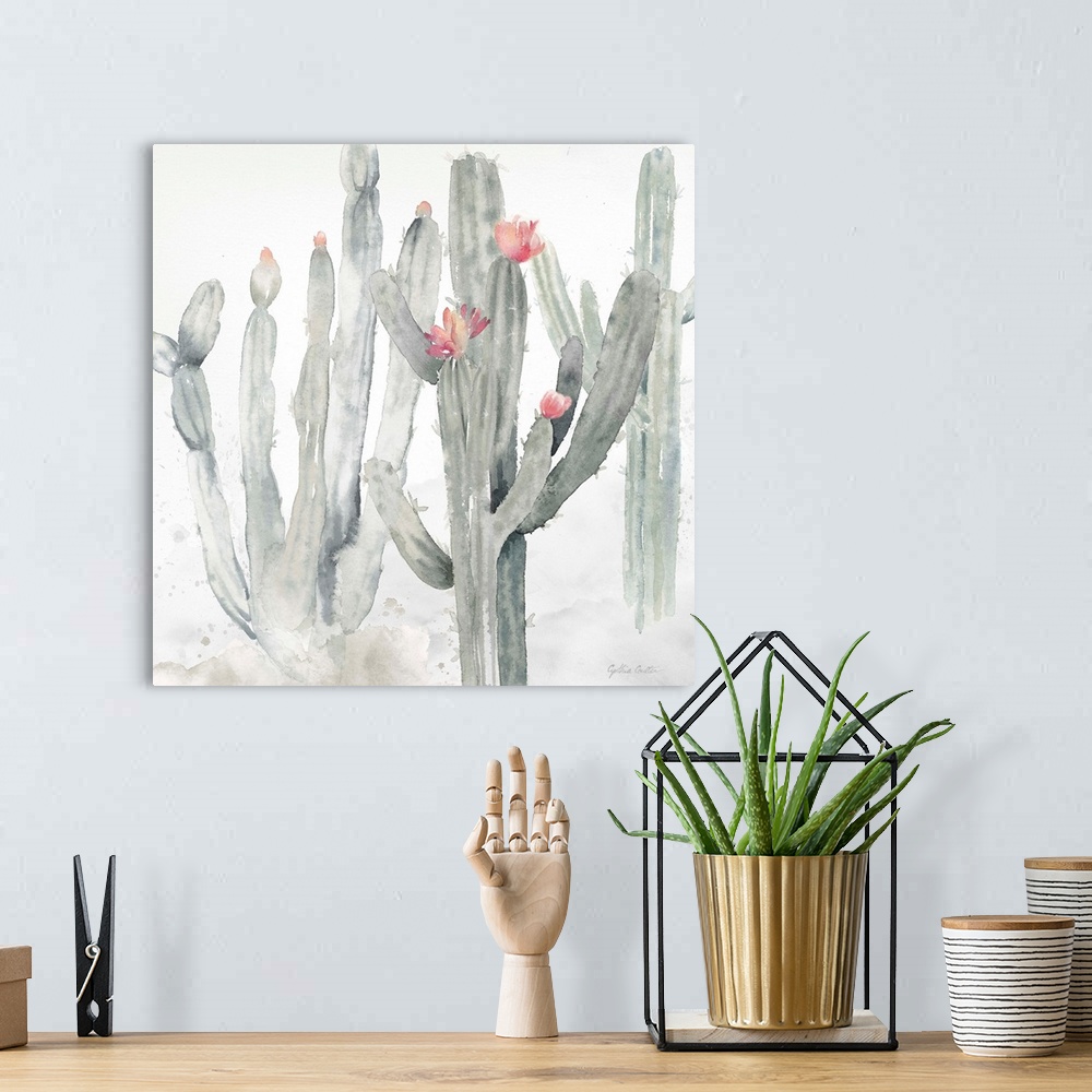 A bohemian room featuring A square decorative watercolor painting of a group of cactus in a garden.