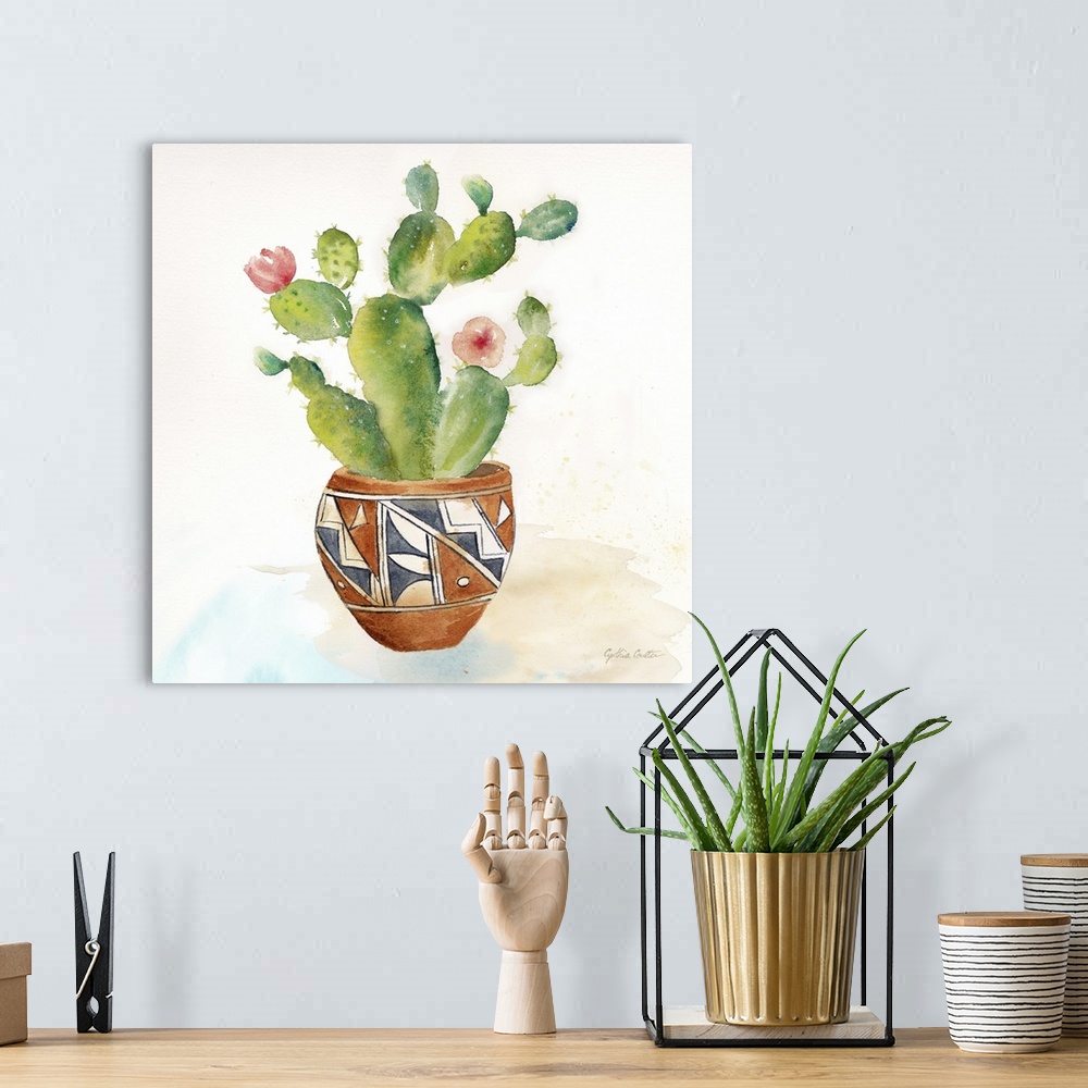 A bohemian room featuring A square decorative watercolor painting of succulents in colorful clay pots.