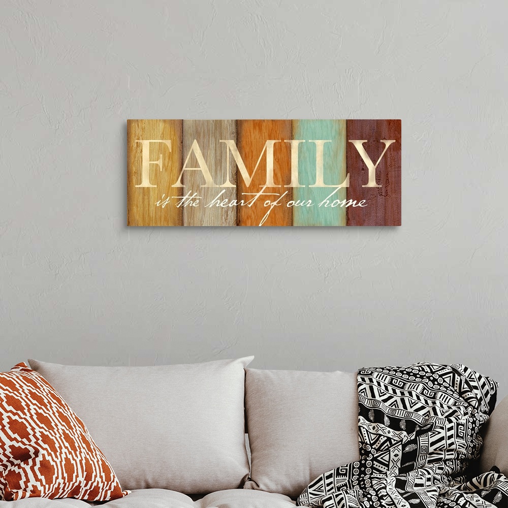 A bohemian room featuring "Family is the heart of our home" on a multi-colored wood plank background.