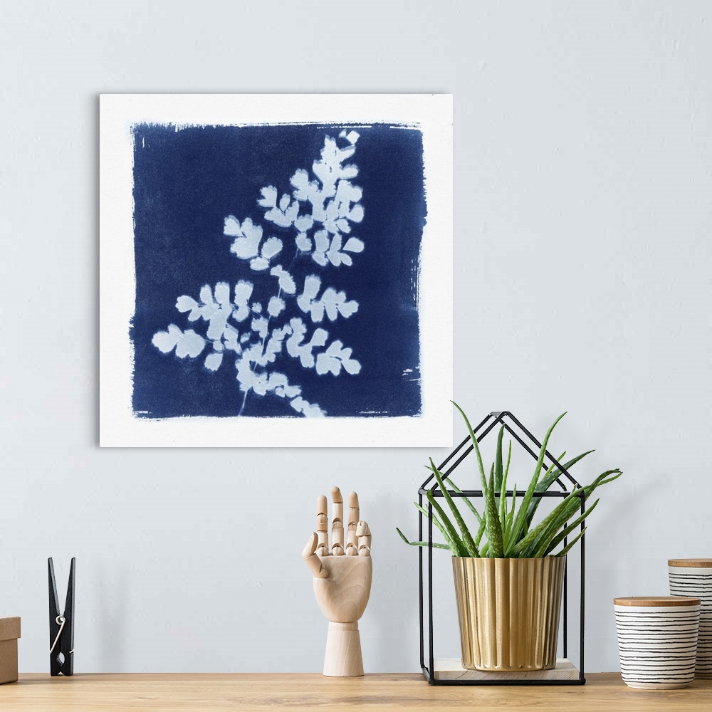 A bohemian room featuring Creative artwork in the style of a cyanotype of a fern with a rough white border.