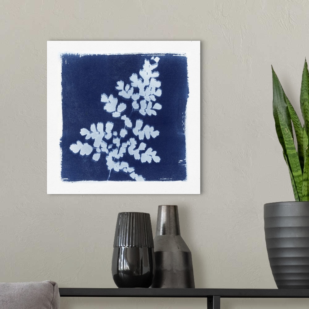 A modern room featuring Creative artwork in the style of a cyanotype of a fern with a rough white border.