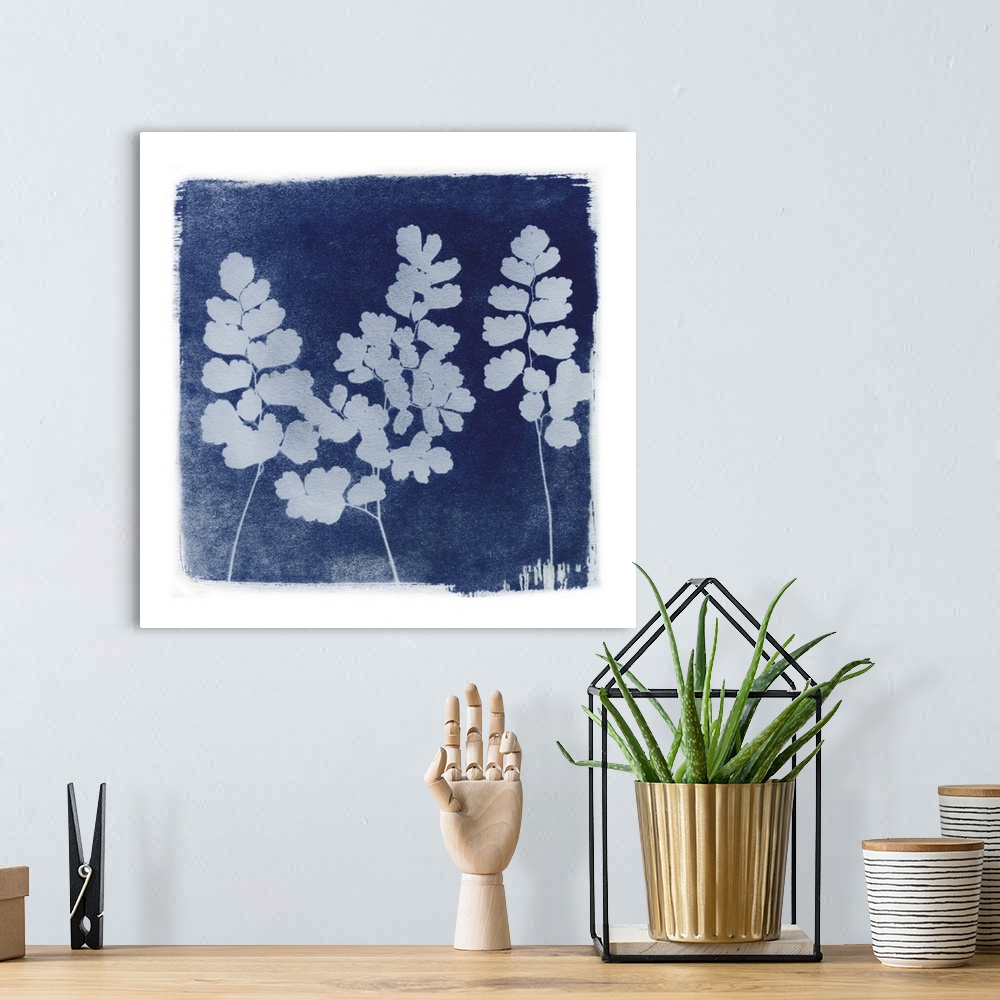 A bohemian room featuring Creative artwork in the style of a cyanotype of ferns with a rough white border.