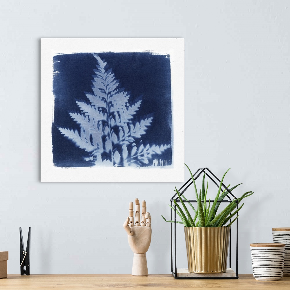 A bohemian room featuring Creative artwork in the style of a cyanotype of a fern with a rough white border.