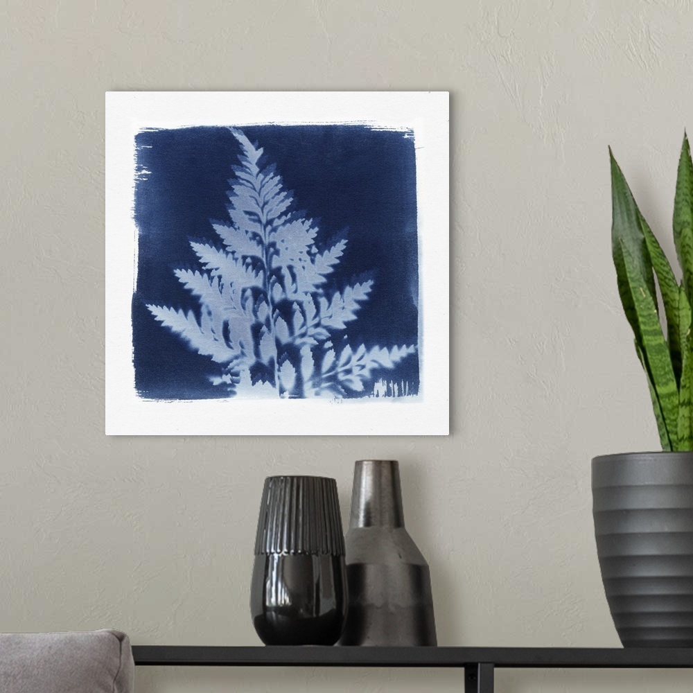 A modern room featuring Creative artwork in the style of a cyanotype of a fern with a rough white border.