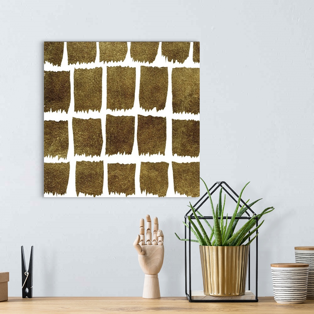 A bohemian room featuring Square decorative artwork of dark gold square shapes  in rows on a white background.
