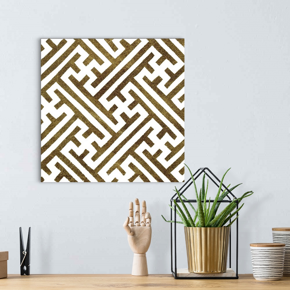 A bohemian room featuring Square decorative artwork of dark gold lines in a maze pattern on a white background.