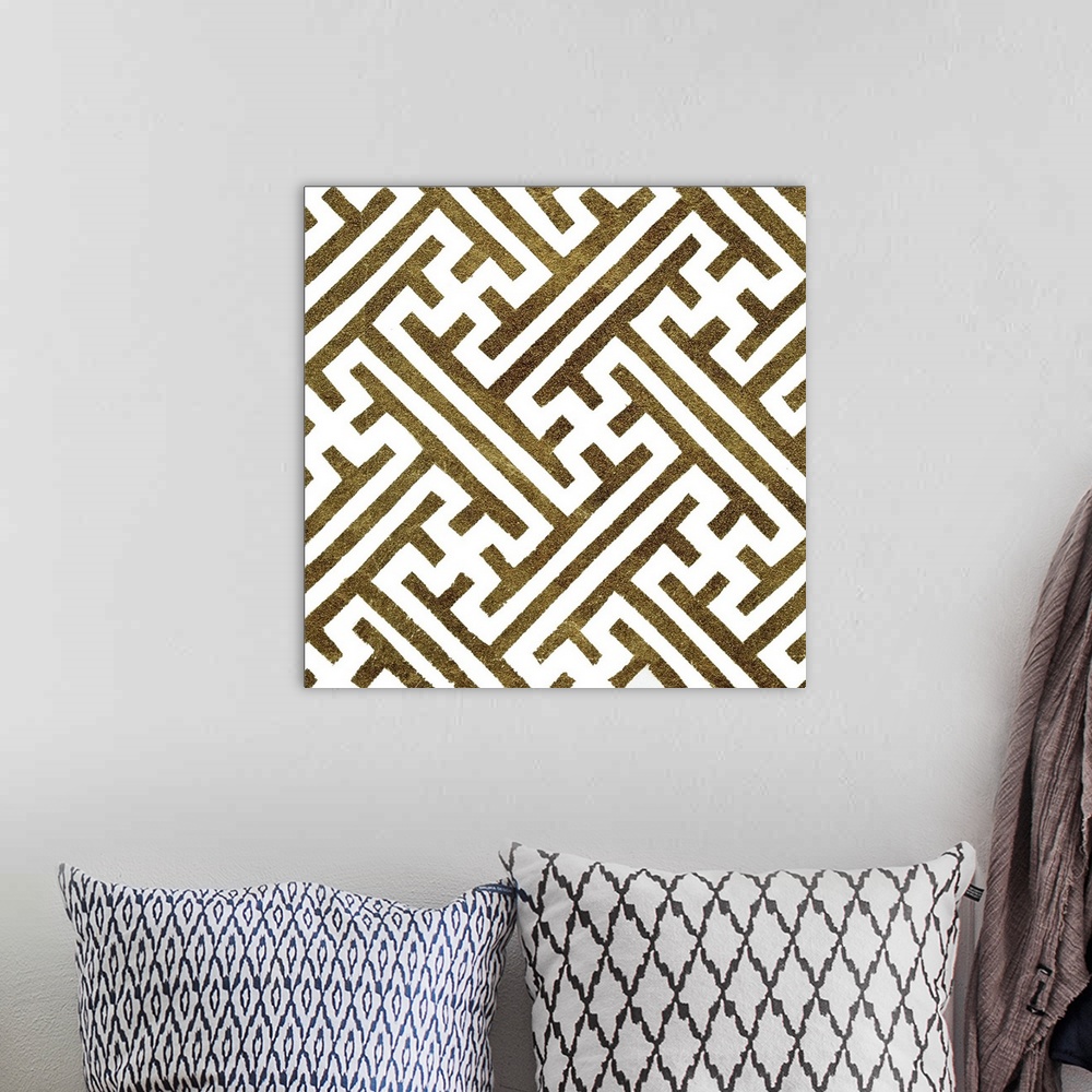 A bohemian room featuring Square decorative artwork of dark gold lines in a maze pattern on a white background.