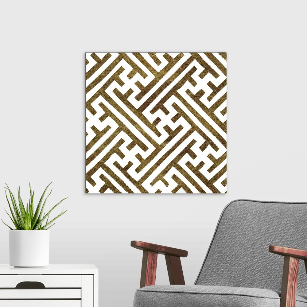 A modern room featuring Square decorative artwork of dark gold lines in a maze pattern on a white background.