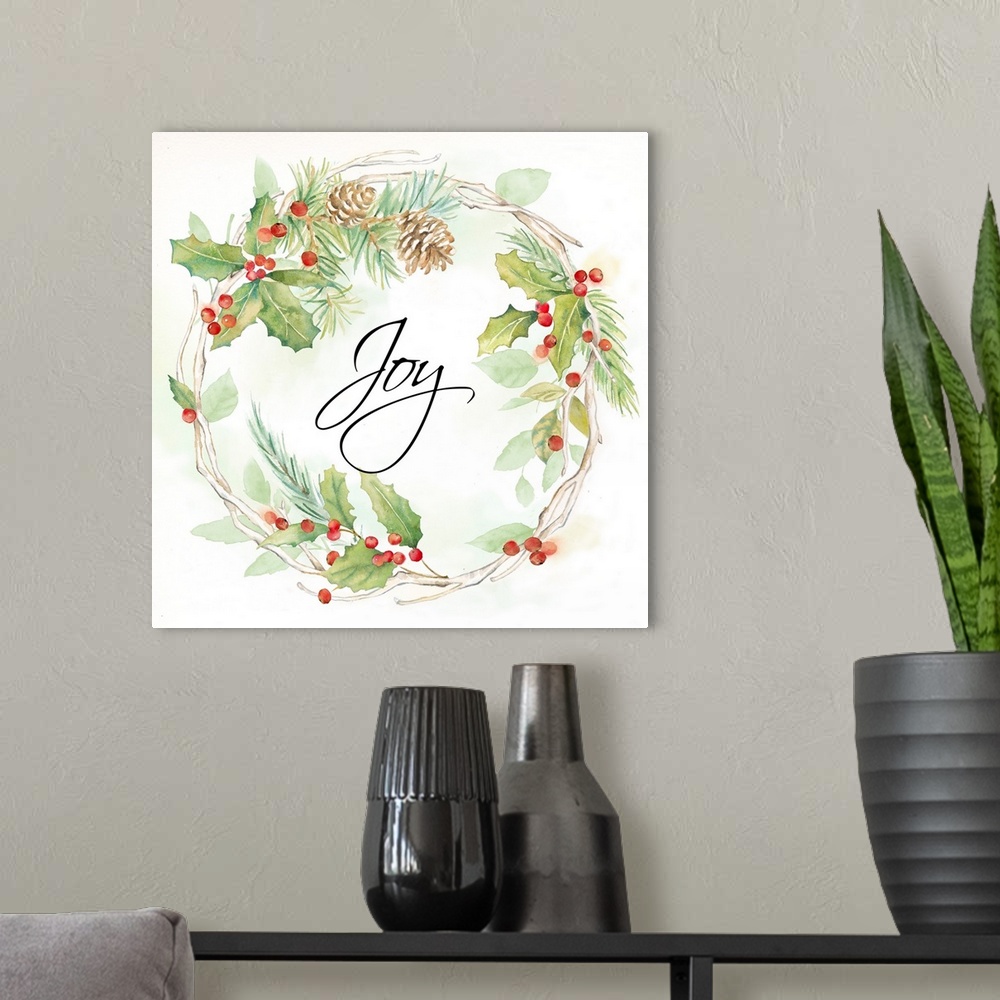 A modern room featuring "Joy" in the center of a holiday wreath of pine and holly.