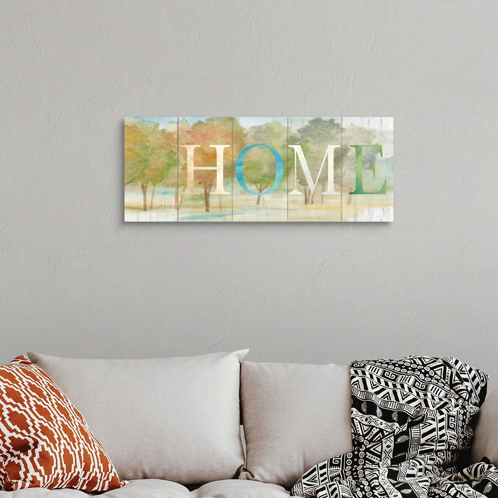 A bohemian room featuring "Home" in blue, white and green over a watercolor image of fall colored trees with a wood plank a...